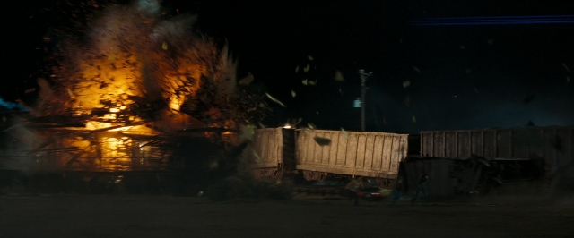 Wide shot frame from Super 8 — walking, fire, night