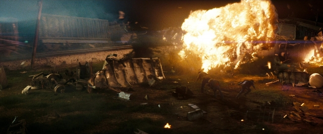 Wide shot frame from Super 8 — train, smoke, person