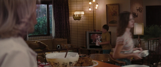 Wide shot frame from Super 8 — standing, plate, room