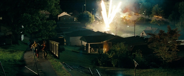 Wide shot frame from Super 8 — walking, fire, night