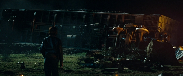 Wide shot frame from Super 8 — standing, train, person