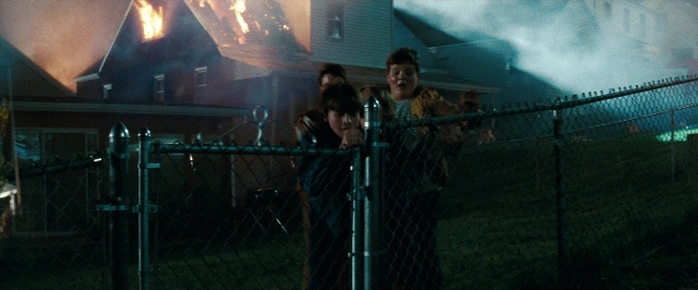 Wide shot frame from Super 8 — standing, fire, smoke