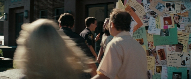 Wide shot frame from Super 8 — walking, street, hand