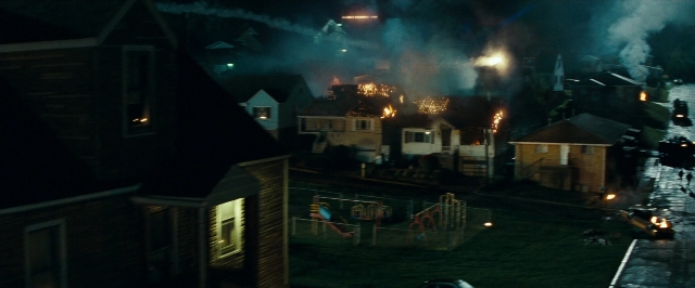 Frame from Super 8 — walking, street, fire