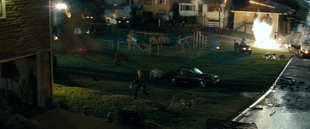 Frame from Super 8 — walking, street, fire