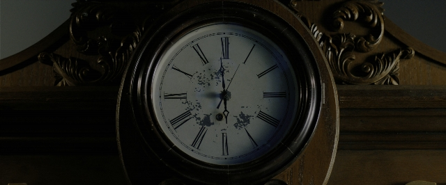 Close-up frame from John Wick: Chapter 3 - Parabellum — hand, face, clock