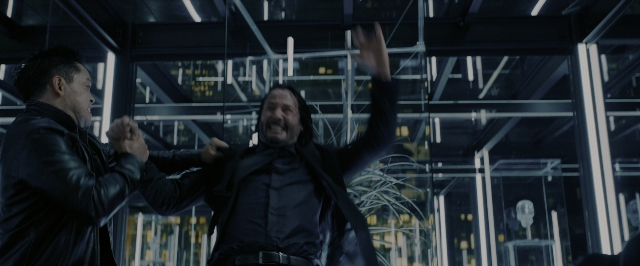 Wide shot frame from John Wick: Chapter 3 - Parabellum — standing, room, hand