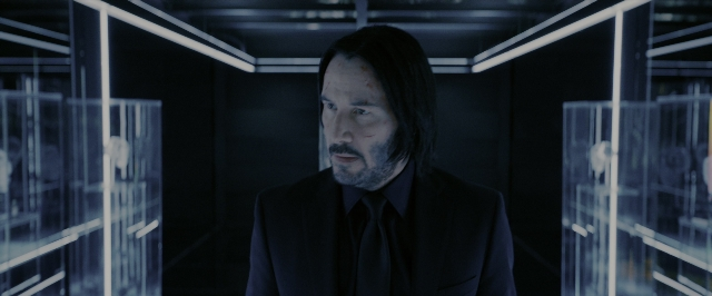 Wide shot frame from John Wick: Chapter 3 - Parabellum — standing, room, suit