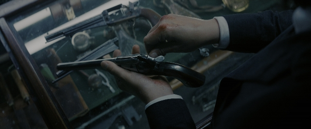 Frame from John Wick: Chapter 3 - Parabellum — room, hand, suit
