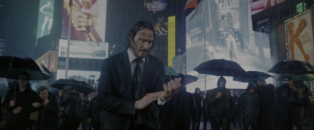 Wide shot frame from John Wick: Chapter 3 - Parabellum — standing, street, hand