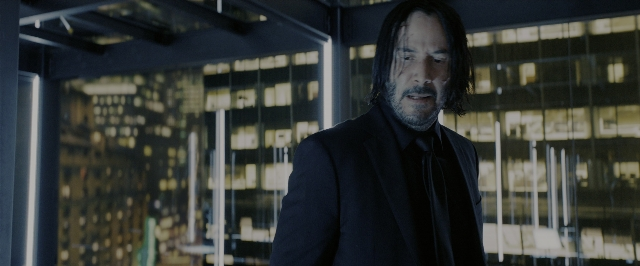 Wide shot frame from John Wick: Chapter 3 - Parabellum — standing, suit, beard