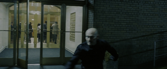 Wide shot frame from John Wick: Chapter 3 - Parabellum — walking, room, door