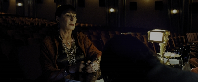Wide shot frame from John Wick: Chapter 3 - Parabellum — sitting, table, face