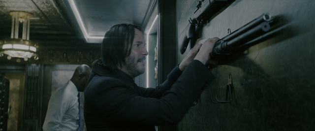 Wide shot frame from John Wick: Chapter 3 - Parabellum — standing, room, coat