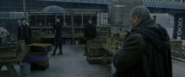 Wide shot frame from John Wick: Chapter 3 - Parabellum — standing, umbrella, person