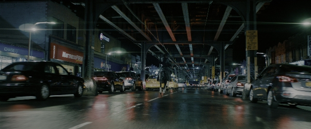Wide shot frame from John Wick: Chapter 3 - Parabellum — walking, street, car