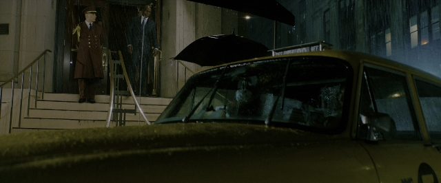 Wide shot frame from John Wick: Chapter 3 - Parabellum — standing, street, hat