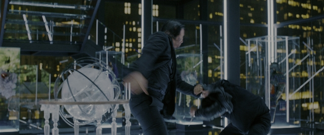 Wide shot frame from John Wick: Chapter 3 - Parabellum — walking, table, hand