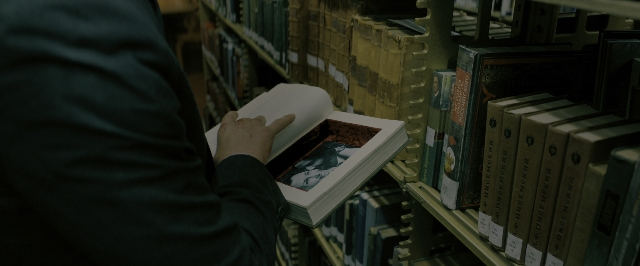 Wide shot frame from John Wick: Chapter 3 - Parabellum — book, standing, hand