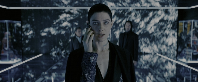 Wide shot frame from John Wick: Chapter 3 - Parabellum — standing, room, phone