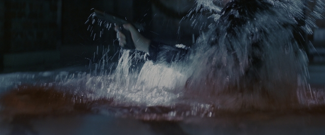 Wide shot frame from John Wick: Chapter 3 - Parabellum — hand, water, gun