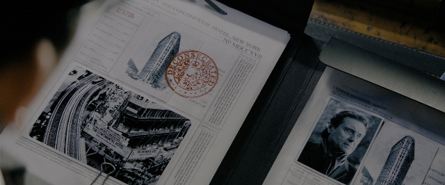 Wide shot frame from John Wick: Chapter 3 - Parabellum — table, suit, tie