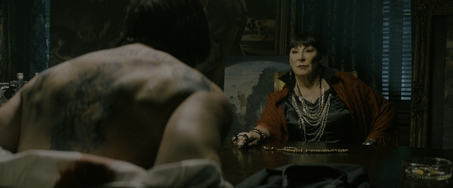Wide shot frame from John Wick: Chapter 3 - Parabellum — sitting, room, table