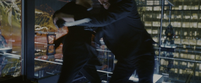 Wide shot frame from John Wick: Chapter 3 - Parabellum — room, hand, suit