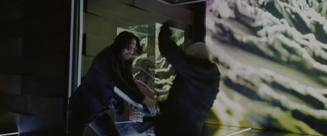 Wide shot frame from John Wick: Chapter 3 - Parabellum — standing, room, hand