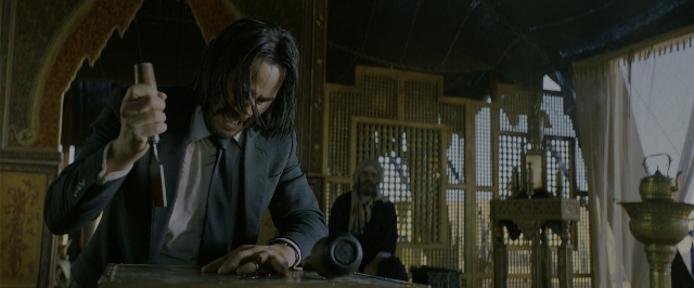 Wide shot frame from John Wick: Chapter 3 - Parabellum — sitting, room, table