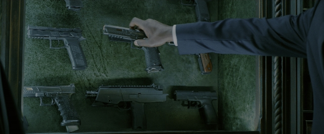 Wide shot frame from John Wick: Chapter 3 - Parabellum — room, hand, suit