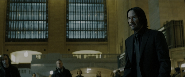 Wide shot frame from John Wick: Chapter 3 - Parabellum — standing, room, suit
