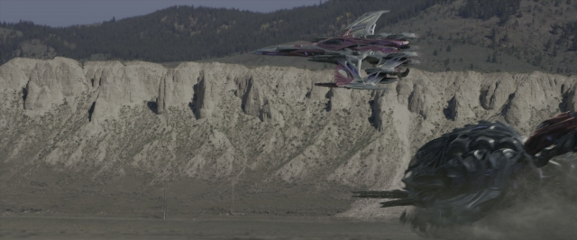 Wide shot frame from Power Rangers — boat, land vehicle, car tire
