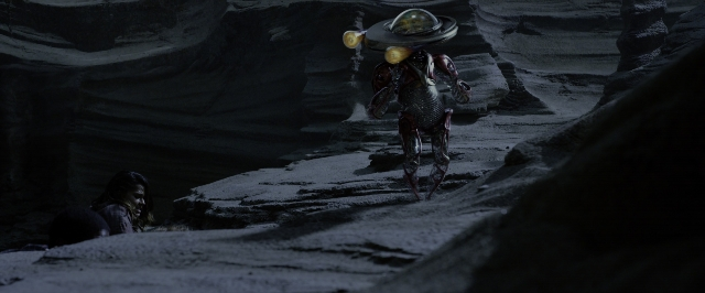 Wide shot frame from Power Rangers — sitting, walking, hat