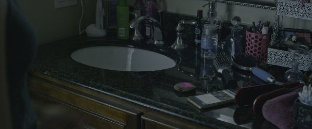 Wide shot frame from Power Rangers — mirror, bathroom, sink