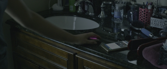 Wide shot frame from Power Rangers — mirror, hand, bathroom