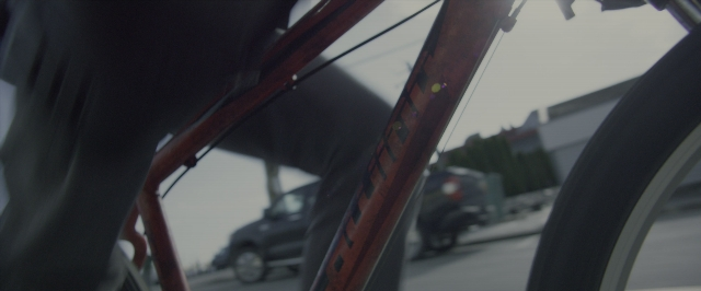 Wide shot frame from Power Rangers — street, bicycle, wheel