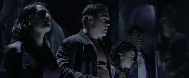 Wide shot frame from Power Rangers — standing, room, face