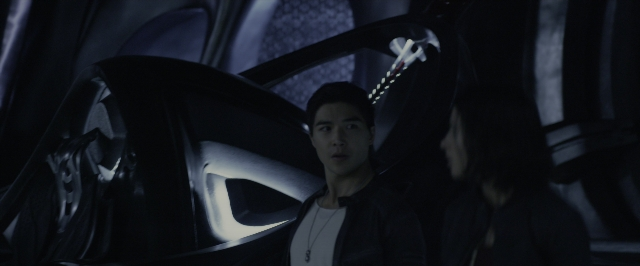 Wide shot frame from Power Rangers — standing, room, car
