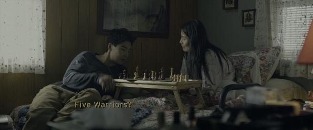 Wide shot frame from Power Rangers — sitting, room, table