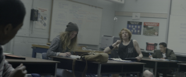 Wide shot frame from Power Rangers — people, sitting, desk