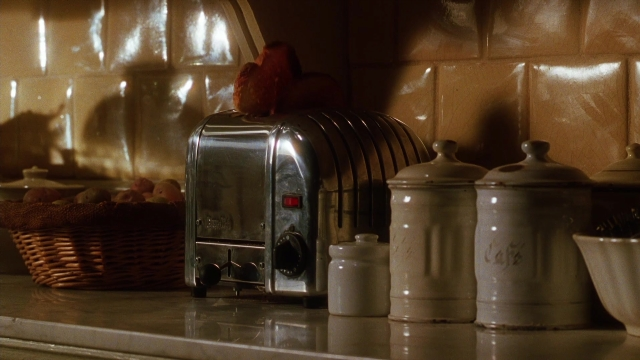 Wide shot frame from Practical Magic — kitchen, toaster, window