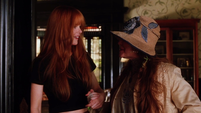 Wide shot frame from Practical Magic — standing, room, dialogue