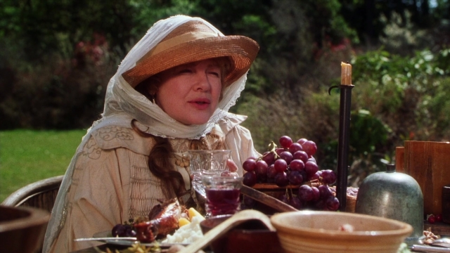 Wide shot frame from Practical Magic — sitting, plate, table