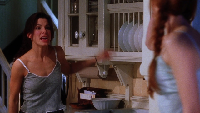 Medium shot frame from Practical Magic — standing, dialogue, kitchen