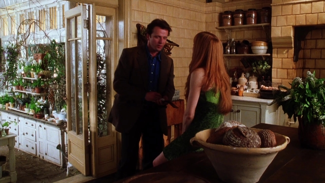 Wide shot frame from Practical Magic — standing, room, table