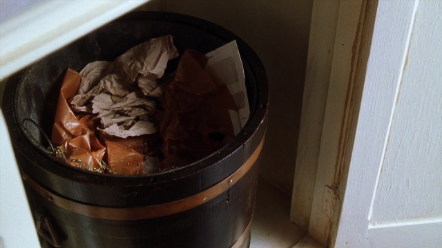 Wide shot frame from Practical Magic — sitting, room, door