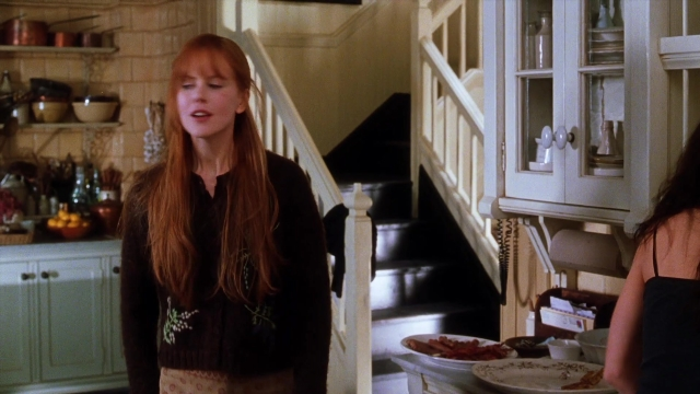 Wide shot frame from Practical Magic — standing, plate, kitchen