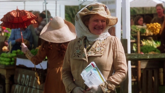 Wide shot frame from Practical Magic — book, standing, hat