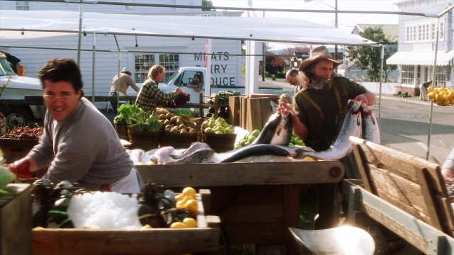 Wide shot frame from Practical Magic — standing, street, hat
